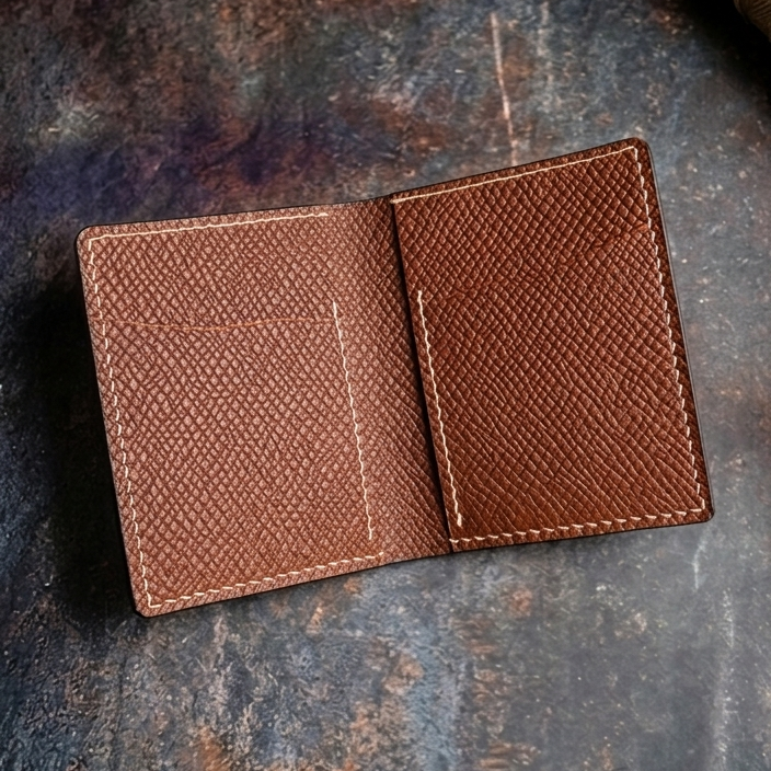 Brown leather wallet on a textured dark surface