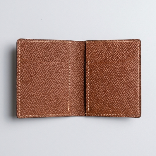 Brown leather wallet on a light gray background